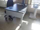 a desk with a computer on it in a room