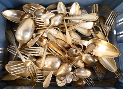 a lot of silver spoons and forks in a blue container