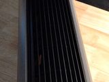 a close up of a black fan on a wooden table