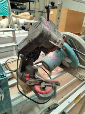 someone is using a circular saw to cut a piece of wood