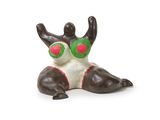 a figurine of a cat with green eyes on a white background