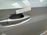 a close up of a car door handle with a sticker on it