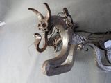 a metal sculpture of a dragon on the wall
