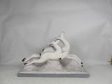 two figurines of a horse and a dog on a white background