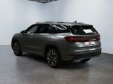 the rear view of a grey suv parked in a showroom