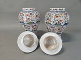 two vases sitting next to each other on a table