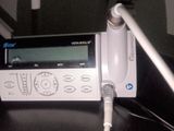a remote control sitting on top of a table next to a laptop