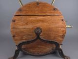 an old wooden table with metal legs and a wooden top