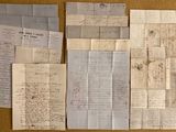 some old papers are laying on top of a table