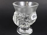 an image of a glass cup sitting on top of a black table