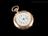 a gold pocket watch with roman numerals on it