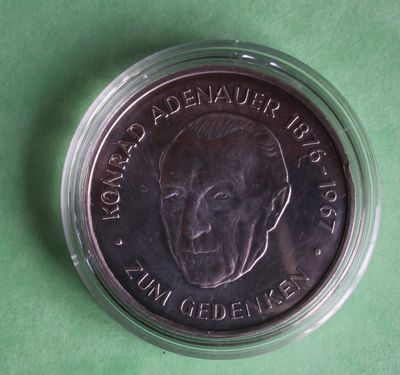 a close up of a coin on a green surface