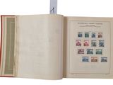 an open book with stamps on it on a white surface