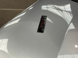 a remote control sitting on the hood of a car