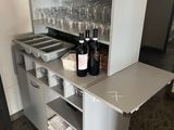 a small cabinet with wine glasses on top of it