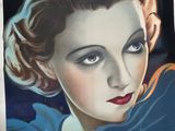 une vieille affiche de cinéma représentant une femme en robe bleue et au rouge à lèvres rouge