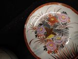 a plate with a bird and flowers painted on it