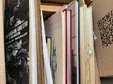 a box full of books sitting on a shelf in a room