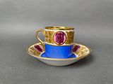 a close up of a cup and saucer on a table