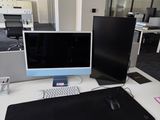 a desk with two monitors and a keyboard on it