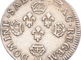 a close up of a silver coin with a crown on it