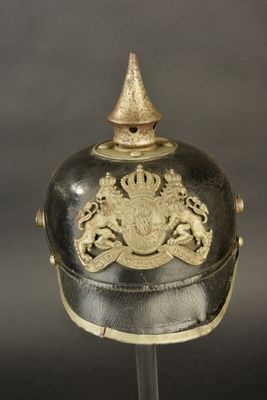 an old helmet with a gold decoration on top of it