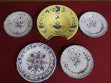 five plates and a bowl sitting on a red table
