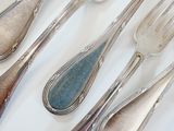 a lot of spoons and forks on the table