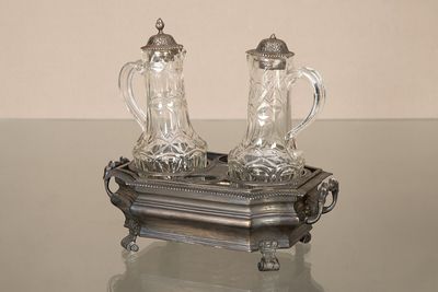 deux salières et poivrières posées sur un plateau, lui-même posé sur une table