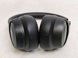 a pair of black headphones on a white surface