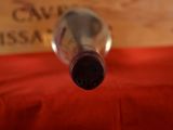 a bottle of wine sitting on a red table cloth