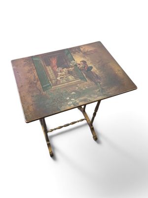 a small table with a painting on it on a white background