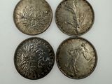 three silver coins, one of which is a woman and one of which is a man