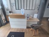 a desk with a chair and a rug in front of it