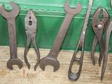 five wrenches sitting next to each other on a table
