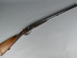 a rifle that is laying on a white surface