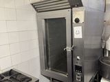 an image of a commercial kitchen with a stove and oven