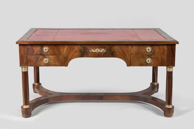an antique writing table with a marble top and two drawers