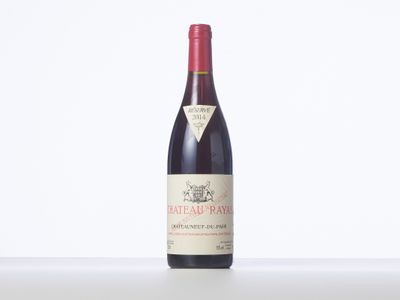a bottle of red wine sitting on top of a table