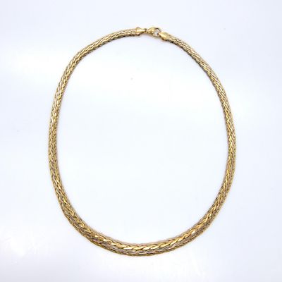 a gold necklace on a white background