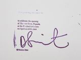 purple ink on a white paper with a purple signature on it