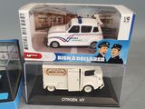 two toy vehicles that are on display in a box