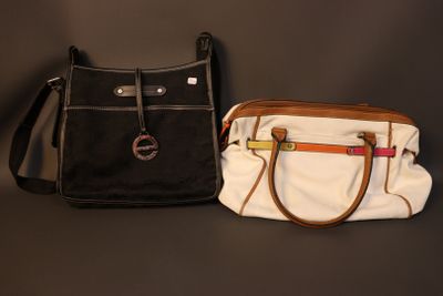 two purses sitting next to each other on a table