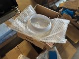 a bowl of water sitting on top of a cardboard box
