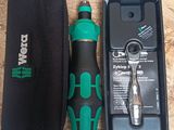 a black and green tool in a case next to a pair of scissors and a pair of scissors