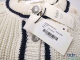 an image of a sweater with a tag on it and a tag attached to it
