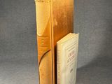 an old book sitting on top of a table next to a book