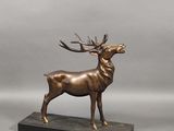 bronze sculpture of a stag on a black marble base