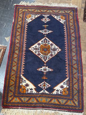 an image of a blue rug with a diamond design on top of it