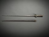 a pair of surgical instruments sitting on top of a gray surface